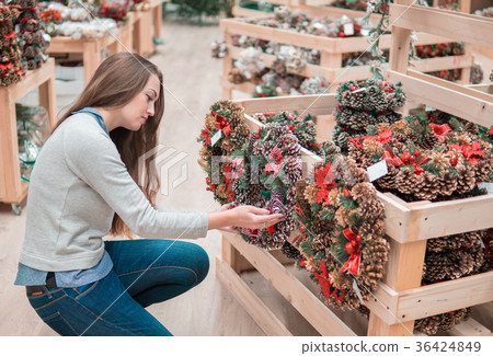 customer girl choosing Christmas decorations customer girl choosing Christmas decorations 36424849