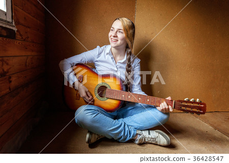 young woman playing guitar young woman playing guitar 36428547