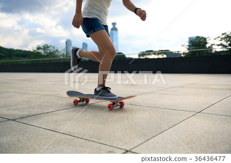 Woman practicing with skateboard at sunrise city Woman practicing with skateboard at sunrise city 36436477