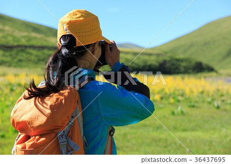woman photographer taking photo in mountains woman photographer taking photo in mountains 36437695