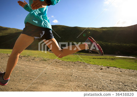 young fitness woman trail runner running outside 36438820