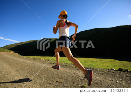 young fitness woman trail runner running outdoors young fitness woman trail runner running outdoors 36438824