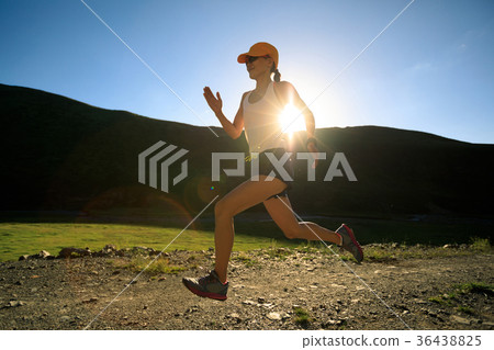 young fitness woman trail runner running outdoors 36438825