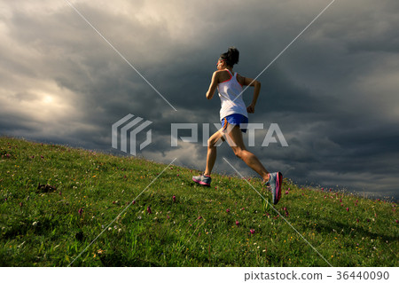 fitness woman runner running on sunset trail fitness woman runner running on sunset trail 36440090