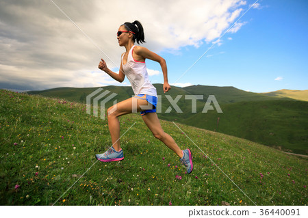 fitness woman runner running on sunset  trail 36440091