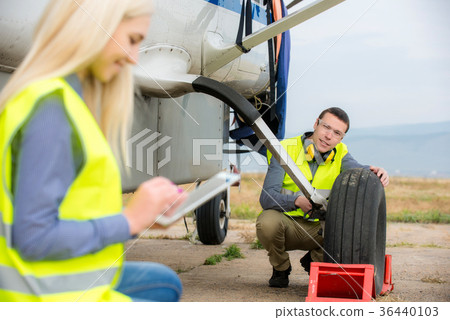Checking aircraft's tire Checking aircraft's tire 36440103