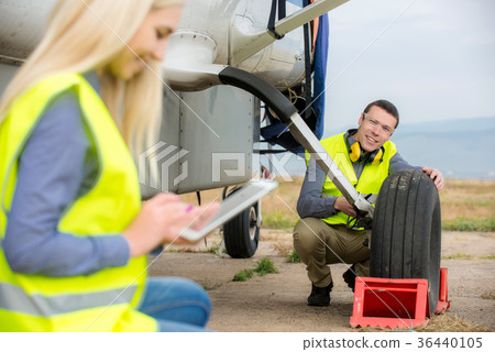 Checking aircraft's tire Checking aircraft's tire 36440105