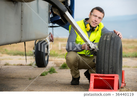 Checking aircraft's tire Checking aircraft's tire 36440119