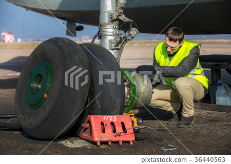 Engineer fixing aircraft's wheel Engineer fixing aircraft's wheel 36440563