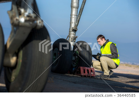 Airport worker checking chassis Airport worker checking chassis 36440585