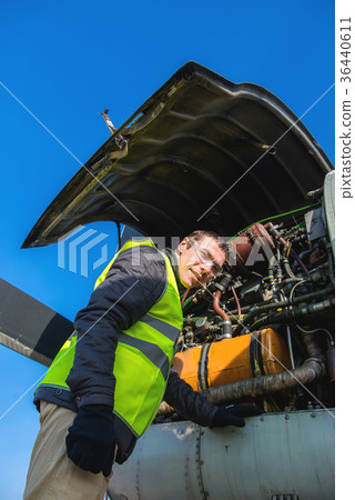 Mechanic near airplanes engine Mechanic near airplanes engine 36440611