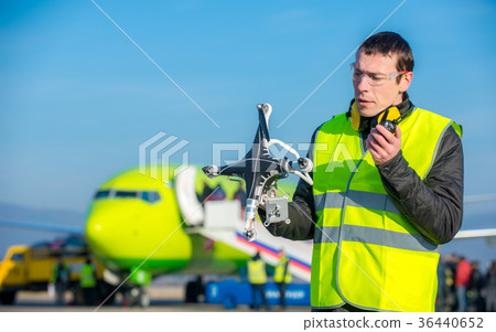 airport worker with crashed drone 36440652