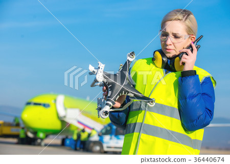 airport worker with crashed drone 36440674