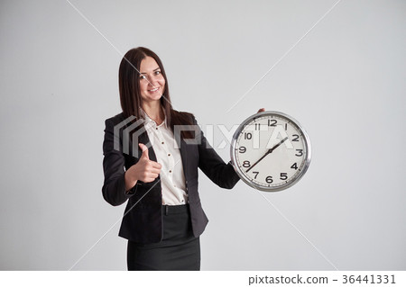 business woman shows on the big round clock , on a 36441331