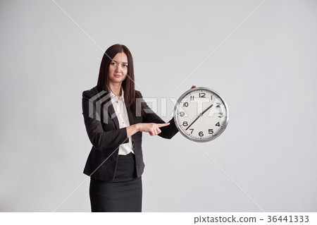 business woman shows on the big round clock , on a 36441333