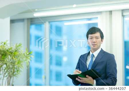 Business man with a notebook Business man with a notebook 36444207