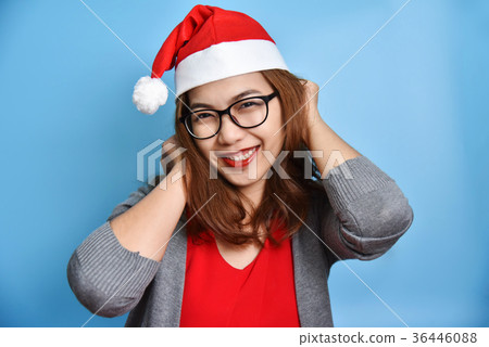 Asian female wear Santa Claus hat smiling. Asian female wear Santa Claus hat smiling. 36446088