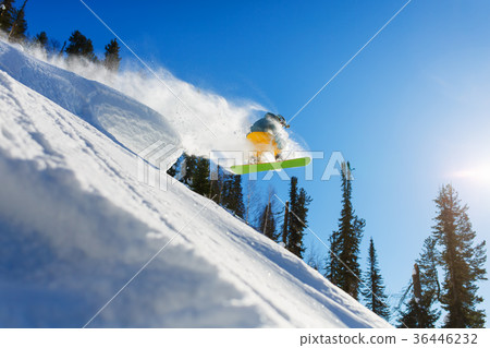 Snowboarder at jump inhigh mountains at sunny day. 36446232