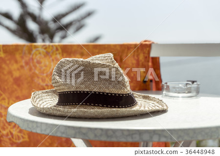 old straw hat on a table 36448948