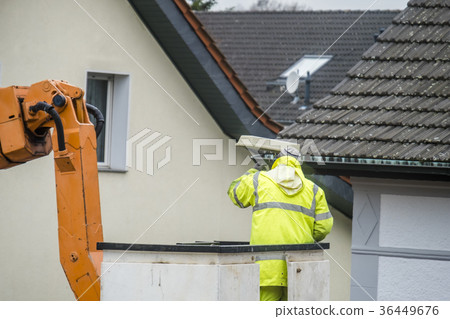 Electrician repairing street lights on lift Electrician repairing street lights on lift 36449676