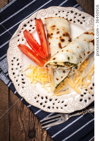 Crepes stuffed with cheese and spinach. 36450916