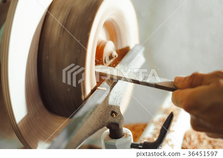 master working on a lathe on wood acceleration 36451597