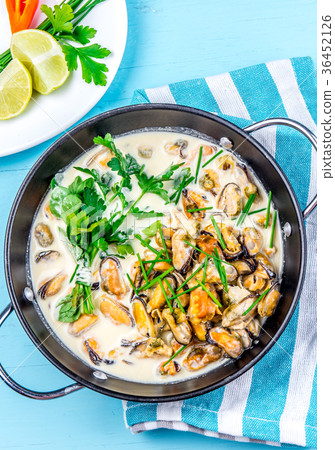 Mussels in creamy milk sauce with aromatic herbs Mussels in creamy milk sauce with aromatic herbs 36452126