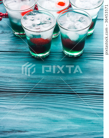 Short alcohol green drinks with cherry Short alcohol green drinks with cherry 36453571