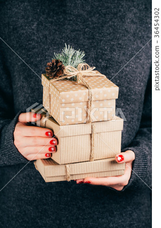 Hands with craft gift boxes Hands with craft gift boxes 36454302
