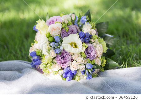Romantic wedding bouquet on blanket and grass Romantic wedding bouquet on blanket and grass 36455126