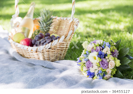 Wicker basket of fruits and wedding bouquet 36455127