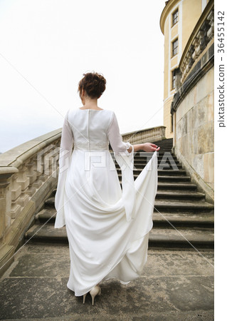Bride in wedding dress on castle stairs 36455142