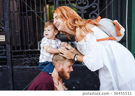 Happy parents playing with little son outdoor Happy parents playing with little son outdoor 36455511