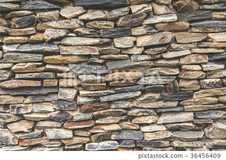 Stacked stone wall background. 36456409