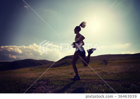 fitness woman runner running on grassland trail fitness woman runner running on grassland trail 36463039