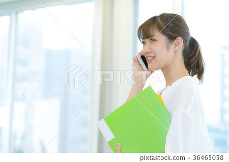 Female office worker having a conversation on smartphone OL Business image Office lady Female office worker having a conversation on smartphone OL Business image Office lady 36465058