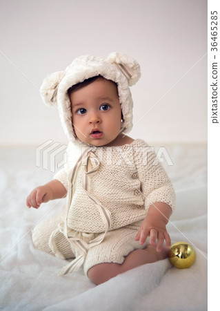 child of eight months sitting in the studio in a 36465285