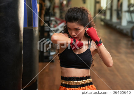 Exercising with punching bag 36465640