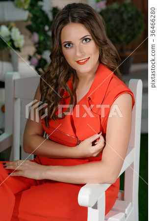 Girl in orange dress in the garden 36466280