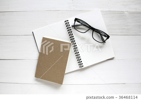Notebook and glasses on white wooden table 36468114