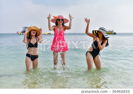 Beautiful woman wearing a swimsuit playing in the beach. 36468850