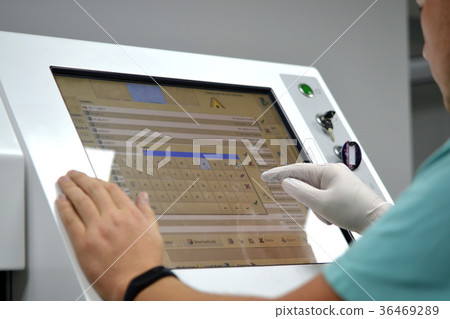 The man works on the machine sensory monitor 36469289