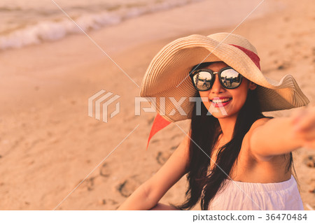 Beautiful girl is walking on the beach happily. Beautiful girl is walking on the beach happily. 36470484
