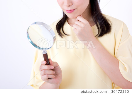 Woman, white background, magnifying glass Woman, white background, magnifying glass 36472350