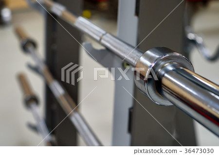 Barbell holder on a blurred gym background 36473030