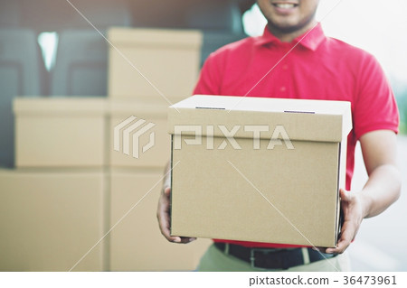 Smiling young male postal delivery courier man  36473961