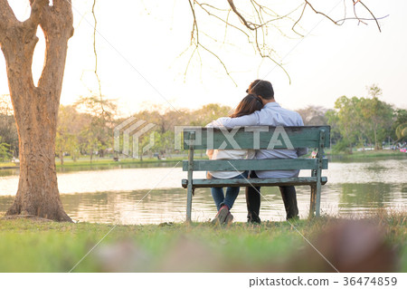 girlfriend and boyfriend sitting on bench girlfriend and boyfriend sitting on bench 36474859