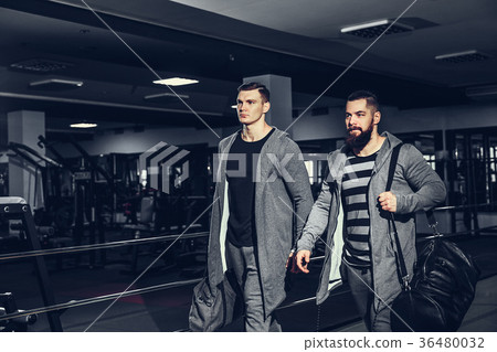 Confident young sportsmen leaving gym 36480032