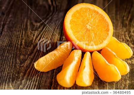 Ripe juicy fresh oranges, whole, cut and slices 36480495
