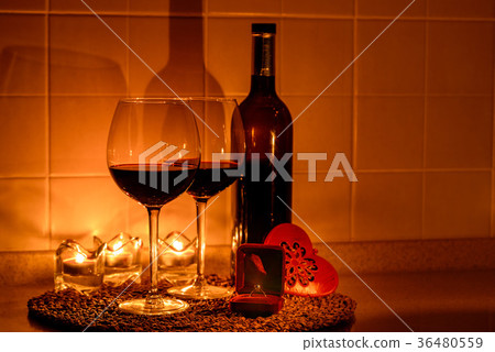 Romantic background with glasses of wine and ring Romantic background with glasses of wine and ring 36480559